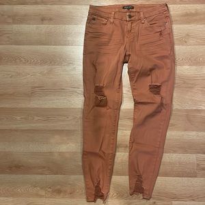 Rusty colored ripped skinny jeans